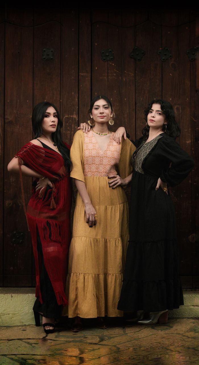 journey Three women in traditional dresses pose in San Cristóbal de las Casas, México.
